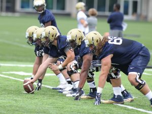 Offensive lineman running snap drills during the first practice of the season (Photo Credit: David Hague)