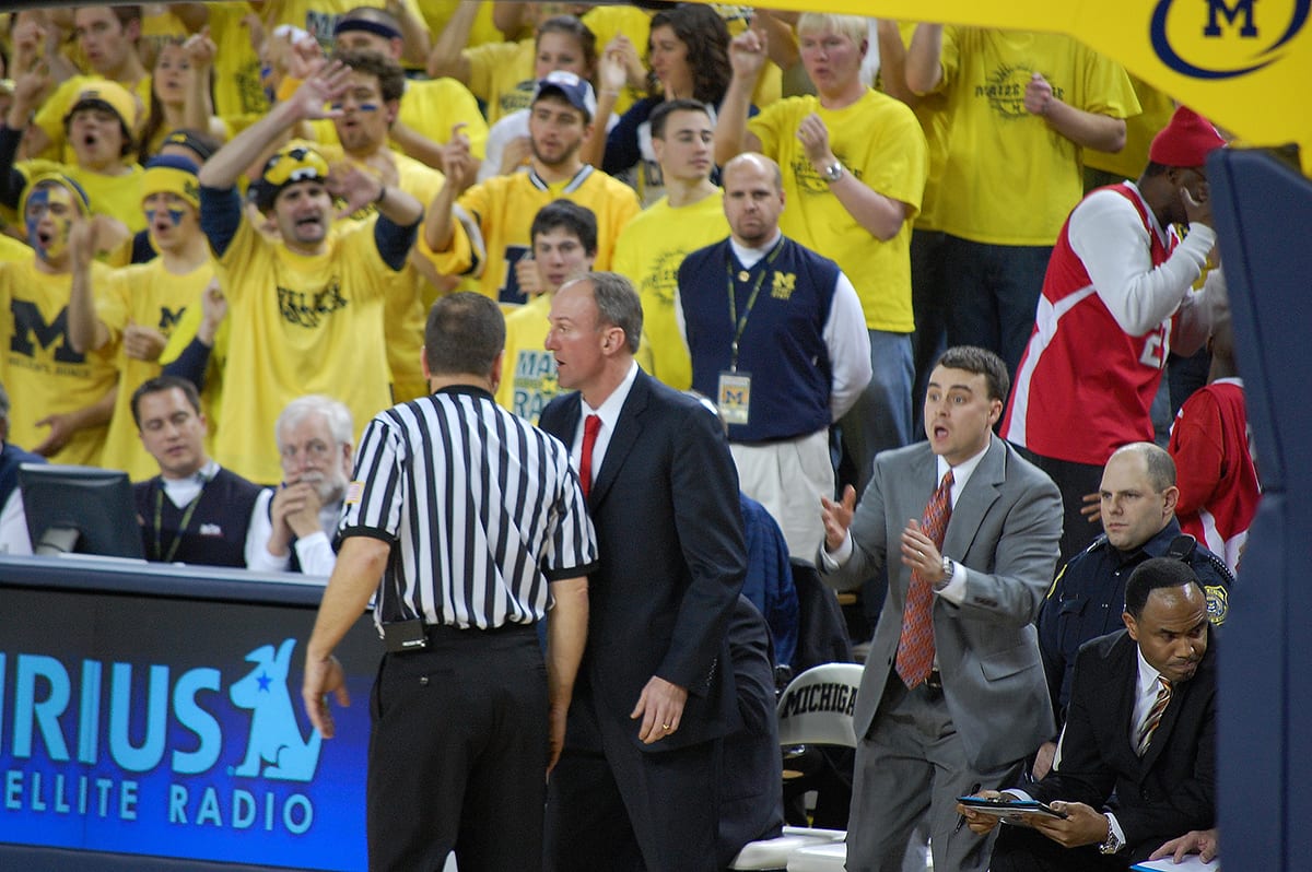 Ohio State University men's basketball coach Thad Matta speaks with a referee during Ohio State's rivalry game vs. Michigan on Jan. 17, 2009 at the Crisler Center. Seated to his right are assistant coaches Archie Miller and Alan Major.