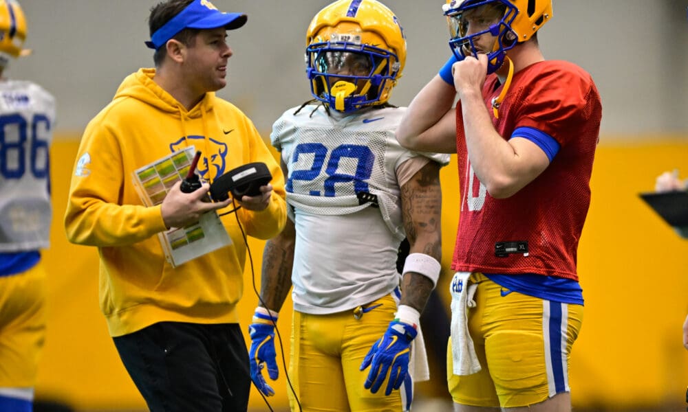 Pitt quarterback Eli Holstein (10) with running back Justin Cook (28) and offensive coordinator. March 27, 2025 / Ed Thompson. PSN.