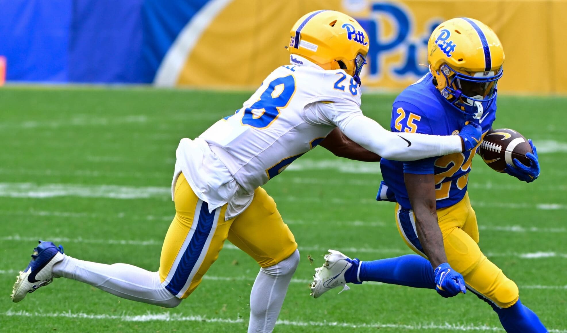 Pitt freshman cornerback Shawn Lee Jr. (28) goes to tackle running back Ja'Kyrian Turner (25). April 12, 2025 / Ed Thompson. PSN.