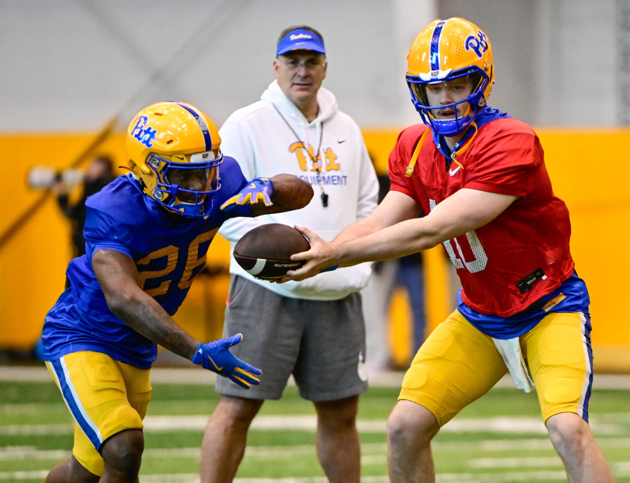 Pitt quarterback Eli Holstein (10) hands it off to running back Juelz Goff (26) during spring practice. April 8, 2025 / Ed Thompson. PSN.