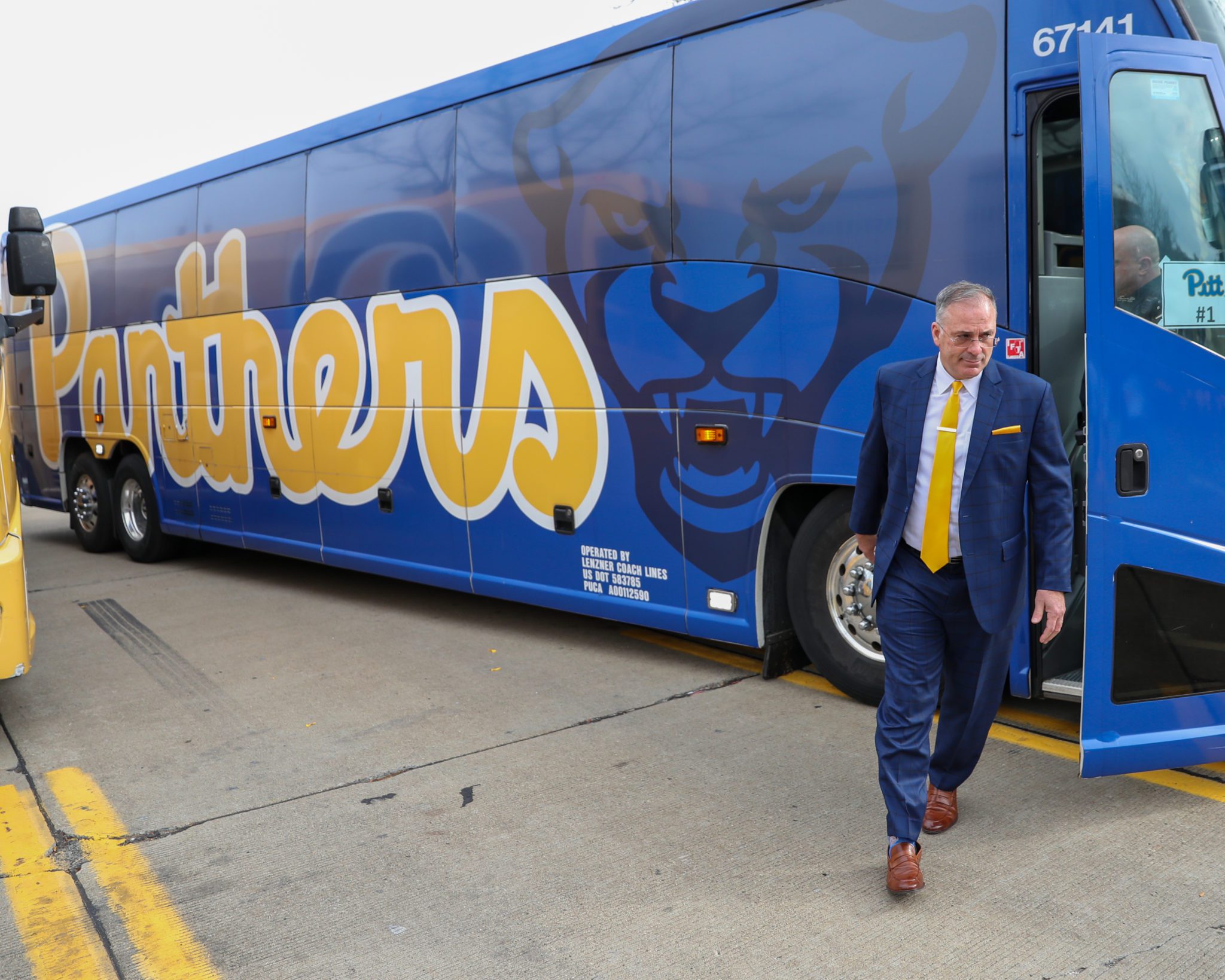 Pitt football bus with head coach Pat Narduzzi coming off.