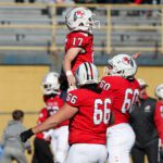 Peters Township quarterback Nolan DiLucia celebrates with his linemen during the first half of the 5A WPIAL Championship Game.