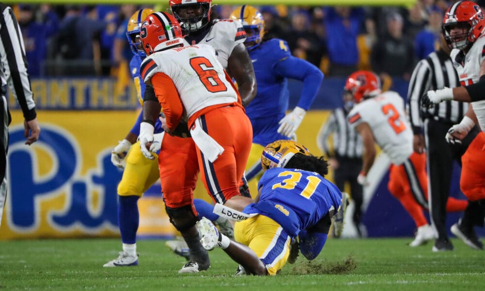 Pitt linebacker Rasheem Biles tackles Syracuse quarterback Kyle McCord