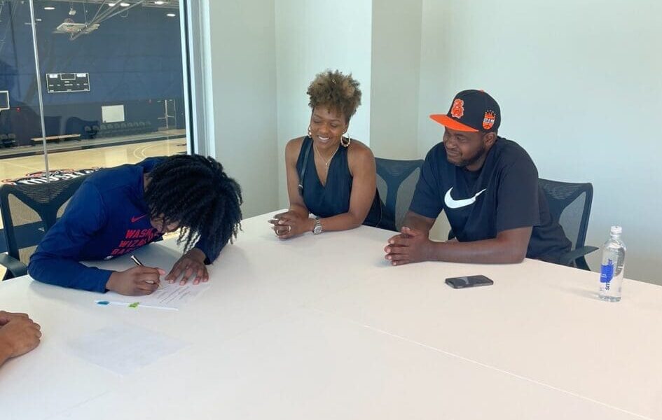 Washington Wizards guard Carlton "Bub" Carrington signs first NBA contract alongside family. Photo via Carrington family.