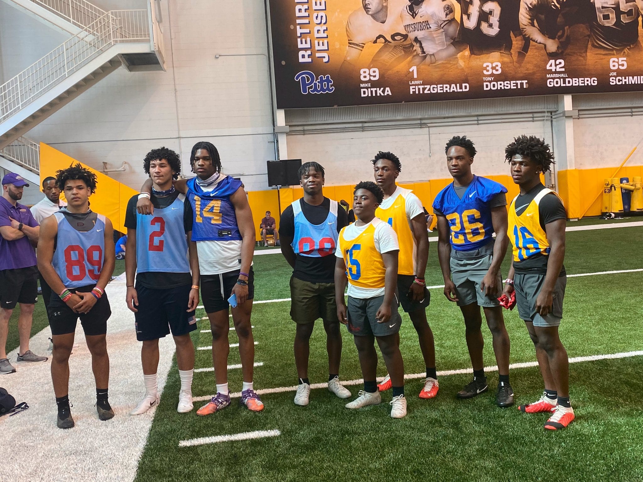 Eight players from Playmakers Academy pose for a picture at Pitt football's recruitment camp.